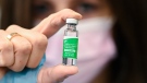 Pharmacist Barbara Violo shows off a vial of the Oxford-AstraZeneca COVID-19 vaccine after providing doses to customers at the Junction Chemist which is a independent pharmacy during the COVID-19 pandemic in Toronto on Friday, March 12, 2021. THE CANADIAN PRESS/Nathan Denette