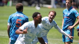 CF Montréal midfielder Djordje Mihailovic, center, celebrates after CF Montréal forward Mason Toye scored during the second half of an MLS soccer match against the Chicago Fire Saturday, May 29, 2021, in Chicago. (AP Photo/Eileen T. Meslar) 
