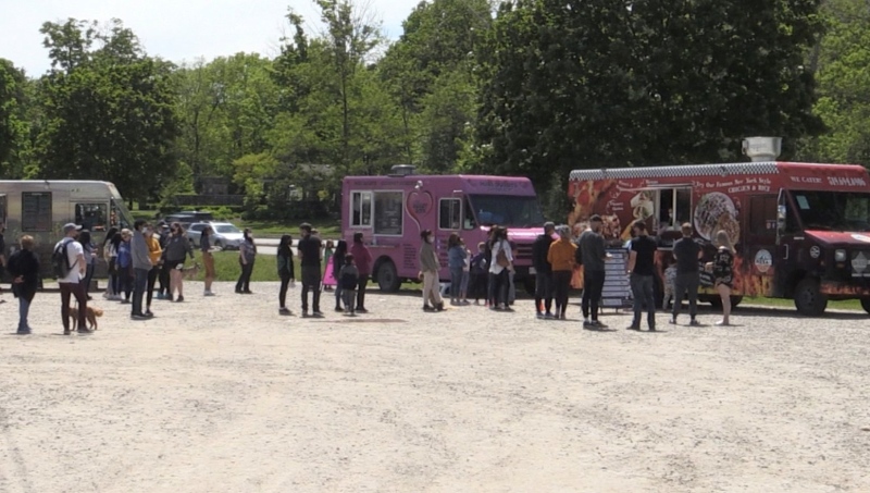 People lined up at the food trucks parked at the kayak launch at Wonderland Road and Riverside Drive on Saturday May 29, 2021 (Bryan Bicknell / CTV News)