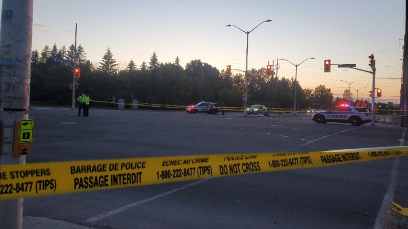 Ottawa police block off the intersection of Woodroffe Avenue and Baseline Road Sunday evening after the fourth shooting in five days in Ottawa. (Aaron Reid/CTV News Ottawa)