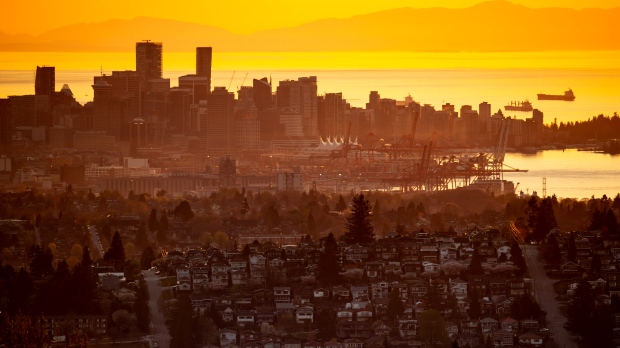 The downtown Vancouver skyline is seen at sunset, as houses line a hillside in Burnaby, B.C., on Saturday, April 17, 2021. THE CANADIAN PRESS/Darryl Dyck 