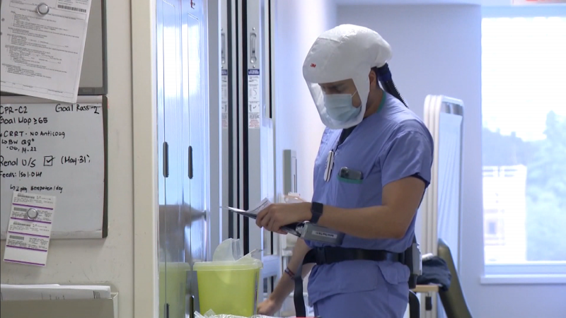 A health-care worker in personal protective equipment is seen in the Surrey Memorial Hospital COVID-19 intensive care unit on June 5, 2021. 