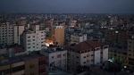 Buildings are partially lit at dusk in Gaza City, Saturday, June 5, 2021. (AP Photo/Felipe Dana)