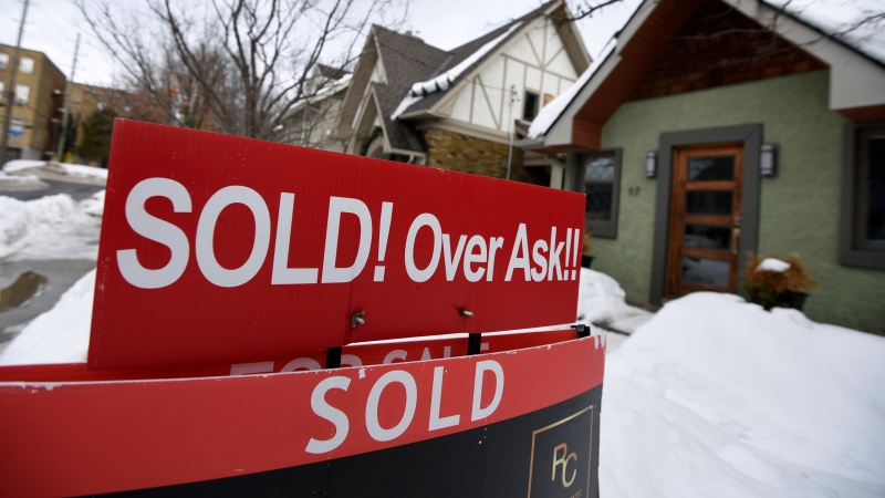 A for sale sign outside a home indicates that it has sold for over the asking price, in Ottawa, on Monday, March 1, 2021. (THE CANADIAN PRESS / Justin Tang)