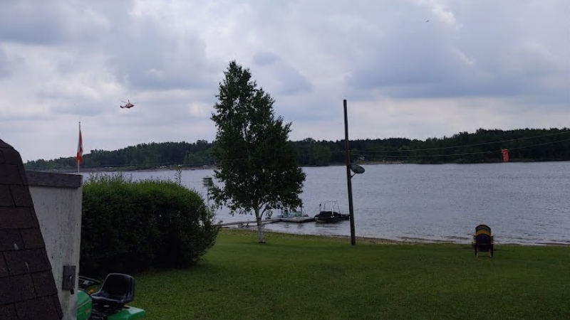A helicopter could be seen flying over Conestogo Lake following reports of a missing person in the water. (Matt Ethier/CTV Kitchener) (June 13, 2021)