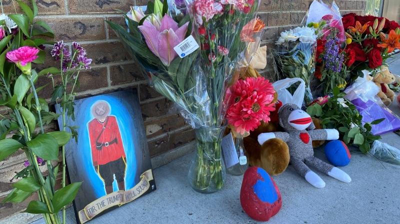 A memorial of flowers grows outside the RCMP detachment in Indian Head, Sask. in memory of Const. Shelby Patton. (Gareth Dillistone / CTV News) 