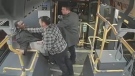 Surveillance video presented in court shows two plainclothes police officers grabbing a young Black man on the TTC. (Court exhibit)