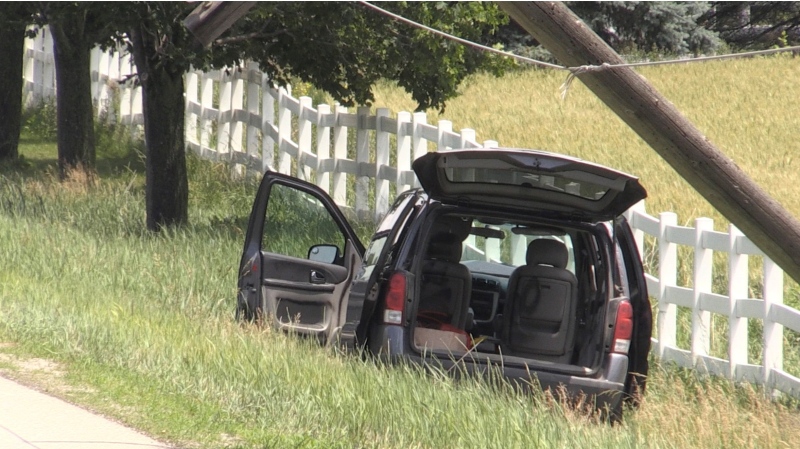 A minivan is seen abandoned north of London, Ont. after it struck a hydro pole Friday, June 18, 2021. (Daryl Newcombe / CTV News)