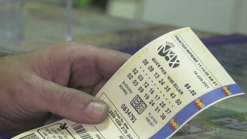 A man holds a Lotto Max ticket in his hand in Barrie, Ont. (Katelyn Wilson/CTV News)