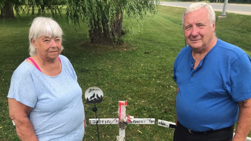 
Judy and Glen Struthers stand before the memorial cross to their Grandson, Justin Struthers. It’s one if 18 infront of the provincial government property leading to the Elgin-Middlesex Detention Centre, June 19, 2021 (Sean Irvine/CTV news)

