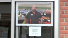 A picture of Troy Scott, 48, a Stroud Foodland owner, is posted outside the grocery store following his death after contracting COVID-19. (Mike Arsalides/CTV News)