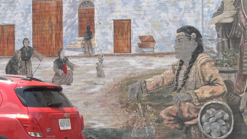 A red handprint can be seen on the mural titled 'Marguerite d’Youville and Her Mission' in downtown Pembroke. 