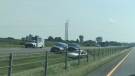 SIU and OPP vehicles are seen where a car rests in the ditch along Highway 401 in Chatham-Kent, Ont. on Wednesday, July 7, 2021. (Sean Irvine / CTV News)