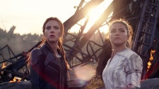 This image released by Marvel Studios shows Scarlett Johansson, left, and Florence Pugh in a scene from "Black Widow." (Marvel Studios-Disney via AP) 