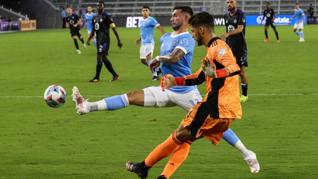 New York City FC midfielder Valentin Castellanos (11) kicks the ball next to CF Montreal goalkeeper James Pantemis (41) during the first half of an MLS soccer match Wednesday, July 7, 2021, in Orlando, Fla. (AP Photo/Gary McCullough) 