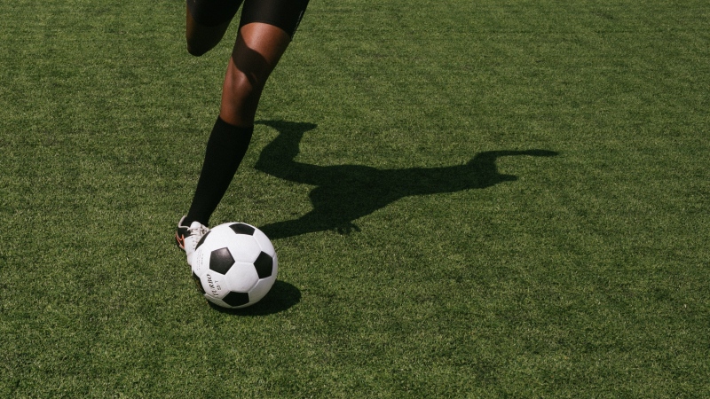 A soccer player and ball are pictured in this file photo. (Pexels)