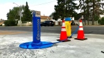 A fire hydrant in west Edmonton converted into a free potable water station. July 14, 2021. (Sean Amato/CTV News Edmonton)