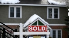 A for sale sign outside a home indicates that it has been sold, in Ottawa, on Monday, March 1, 2021. (THE CANADIAN PRESS / Justin Tang)