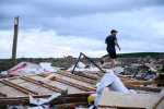 A resident surveys the damage left after a tornado touched down in his neighbourhood, in Barrie, Ont., on Thursday, July 15, 2021. THE CANADIAN PRESS/Christopher Katsarov