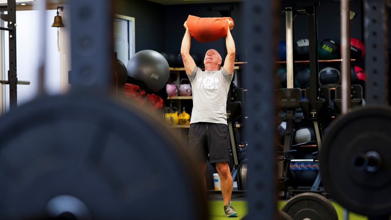 Paul Roberston works out at Crossfit Bytown as patrons return to the gym as Ontario enters phase 3 of reopening during the COVID-19 pandemic in Ottawa on Friday, July 16, 2021. (Sean Kilpatrick/THE CANADIAN PRESS)