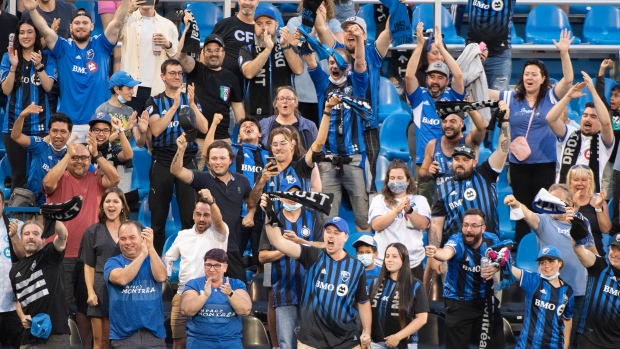 CF Montreal fans celebrate a goal during first half MLS soccer action against FC Cincinnati in Montreal, Saturday, July 17, 2021. THE CANADIAN PRESS/Graham Hughes 