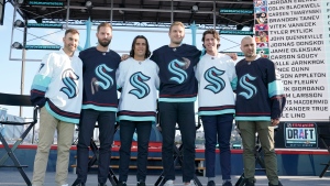 Seattle Kraken NHL hockey players Jordan Eberle, Chris Dreidger, Brandon Tanev, Jamie Oleksiak, Hadyn Fluery and Mark Giordano, from left, pose for a photo Wednesday, July 21, 2021, after being introduced during the Kraken's expansion draft event in Seattle. (AP Photo/Ted S. Warren) 