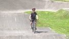 Sam Wheildon, 11, seen biking to raise money for research into a rare genetic mutation. (Peter Szperling/CTV News Ottawa)