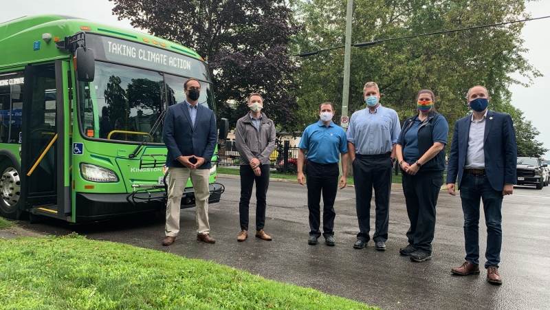 From left: Kingston and the Islands MP Mark Garretson, Kingston city councillor Robert Kiley, Kingston transit services director Jeremy DaCosta, and mayor Bryan Paterson stand with transit operators as the city unveils its new fully electric buses. (Kimberley Johnson / CTV News Ottawa)

