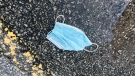 A surgical mask is left on the ground near a puddle in Barrie, Ont. (CTV News Barrie)