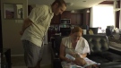 Marie and Taylor Schultz admiring their new baby boy. (Mackenzie Read/CTV News)

