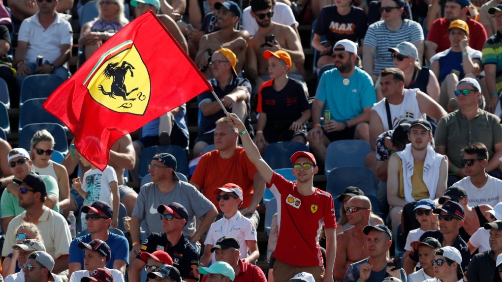 A fan waves a Ferrari flag