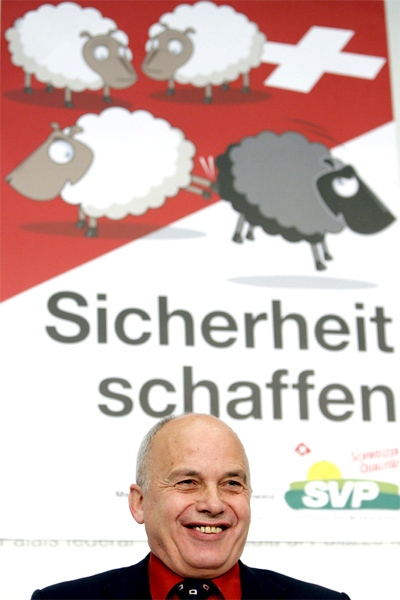 Ueli Maurer, president of the Swiss People's Party SVP, smiles in front of a campaign poster reading "create security", during a press conference in Bern, Switzerland, in this July 13, 2007 file picture. (AP / Keystone, Peter Klaunzer)