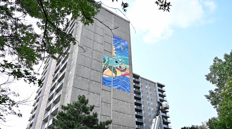 Claudia Salguero's mural being installed on the Ottawa Community Housing Building on Bank Street. (Joel Haslam/CTV News Ottawa)