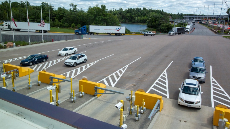 Cars wait to enter Canada at the Thousand Islands U.S./Canada border crossing in Lansdowne, Ontario, on Friday July 30, 2021. (THE CANADIAN PRESS / Lars Hagberg)