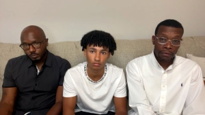 Roy Thorne, left, is seen with his 15-year-old son Samuel, middle, and realtor Eric Brown. All three were handcuffed by Wyoming, Michigan, police officers while touring a home. (CNN)