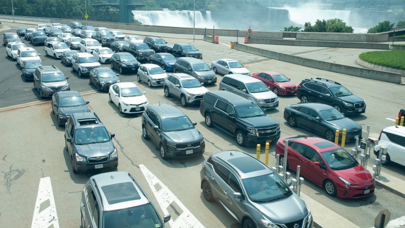 Cars wait on the Rainbow Bridge before crossing the border into Canada, in Niagara Falls, Ont. on Monday, August 9, 2021. American citizens and permanent residents are now allowed to enter Canada for non-essential purposes if they can provide proof that they’ve been fully vaccinated for at least 14 days.THE CANADIAN PRESS/Eduardo Lima 