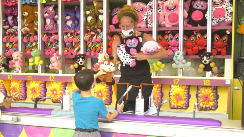 A child wins a prize at the Kanata Fun Fair in Ottawa, Ont. Aug. 10, 2021. (Shaun Vardon / CTV News Ottawa)