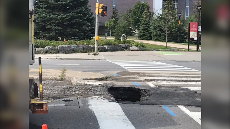 A small sinkhole opened on Bronson Avenue Thursday morning after a watermain break. (Photo courtesy: Twitter/ShawnMenard1)