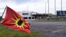 A Mohawk Warrior flag flies in front of the Canadian border crossing station as they block the Seaway Bridge in the Mohawk community of Akwesasne on Cornwall Island, Ont., Monday, June 1, 2009. The Mohawks are protesting the arming of Canada Customs guards with guns. (THE CANADIAN PRESS/Ryan Remiorz)