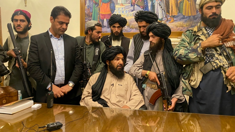 Taliban fighters take control of Afghan presidential palace after the Afghan President Ashraf Ghani fled the country, in Kabul, Afghanistan, Sunday, Aug. 15, 2021. (AP Photo/Zabi Karimi) 