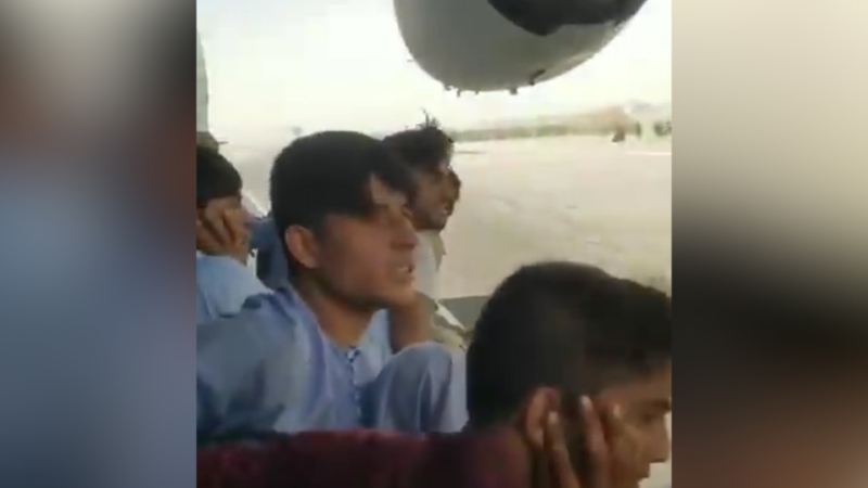 Images and video from Kabul, Afghanistan, show Afghans' desperate attempts to flee the country amid the Taliban takeover of the capital.