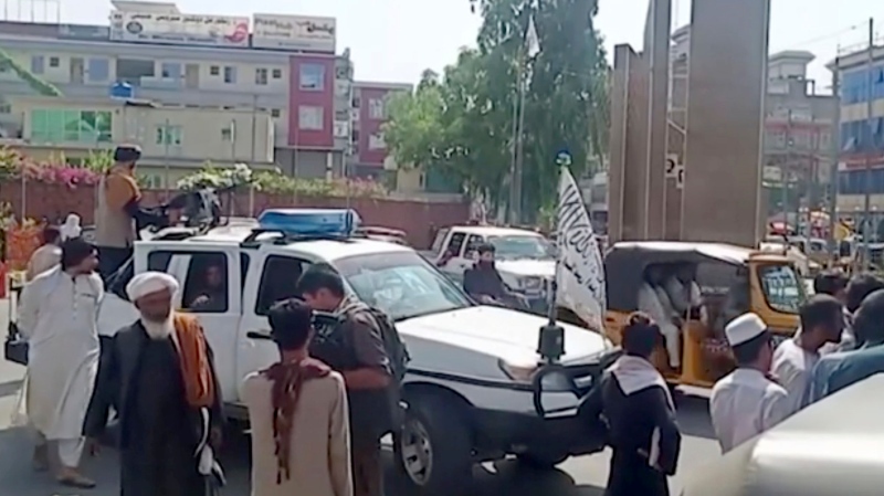 Taliban fighters gather around a vehicle during a protest in Jalalabad, Afghanistan on Wednesday, Aug. 18, 2021. Taliban militants have attacked protesters in eastern Afghanistan who dared to take down their banner and replace it with the country’s flag. (AP Photo) 