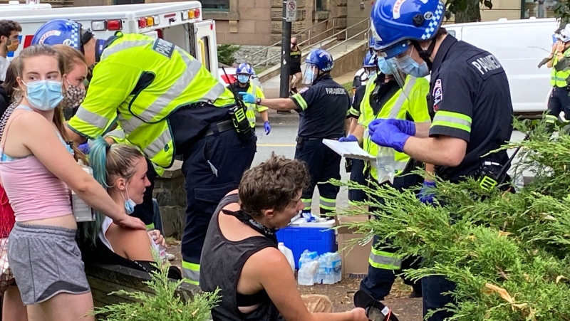 Paramedics administer aid to people who were pepper sprayed at protests that erupted Wednesday in Halifax⁦ after city staff removed several temporary homeless shelters across the city. (Photo via Todd Battis / CTV Atlantic)