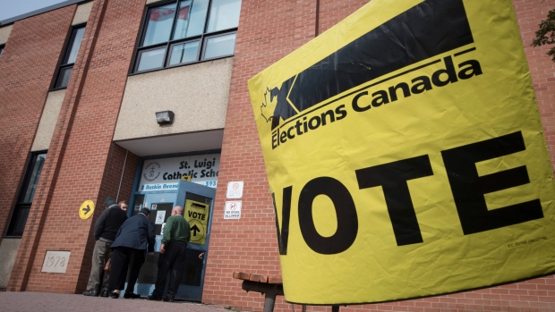Voters enter the polling station at St. Luigi Catholic School during election day in Toronto on Monday, October 21, 2019. THE CANADIAN PRESS/ Tijana Martin 