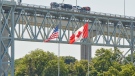 Trucks cross the Bluewater Bridge between Sarnia, Ont., and Port Huron, Mich., Sunday, Aug. 15, 2021. THE CANADIAN PRESS/ Geoff Robins