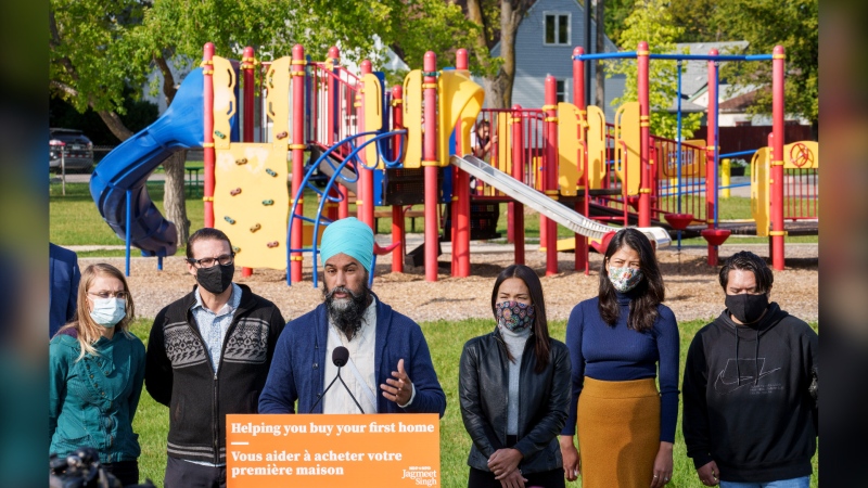 NDP Leader Jagmeet Singh responds to questions surrounded by candidates and supporters in a park in Winnipeg, Thursday, Aug. 26, 2021. THE CANADIAN PRESS/Paul Chiasson 