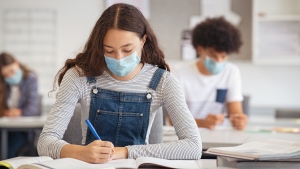 A high school student wears a face mask to curb the spread of COVID-19 in class in this undated image. (Shutterstock)