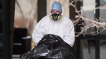 A body is removed from Maison Herron, a long term care home in the Montreal suburb of Dorval, Que., on Saturday, April 11, 2020, as COVID-19 cases rise in Canada and around the world. THE CANADIAN PRESS/Graham Hughes 