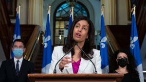 Quebec Liberal Leader Dominique Anglade speaks at the news conference marking the end of the spring session, Friday, June 11, 2021 at the legislature in Quebec City. Anglade is flanked by Liberal legislature leader Andre Fortin, left, and party whip Filomena Rotiroti. THE CANADIAN PRESS/Jacques Boissinot 