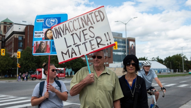 Amid condemnation from officials, a few dozen protesters rally against vaccine mandates outside Ottawa Hospital